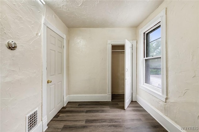 76 Chester St, Buffalo, NY 14208 - unfurnished bedroom featuring dark wood finished floors, a textured wall, and a textured ceiling