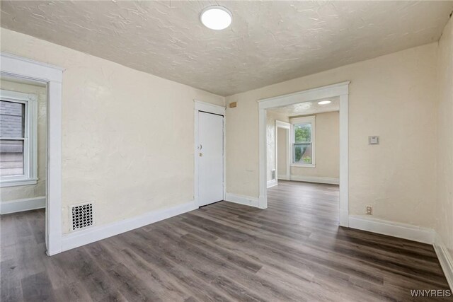 76 Chester St, Buffalo, NY 14208 - empty room featuring dark wood-type flooring and a textured ceiling