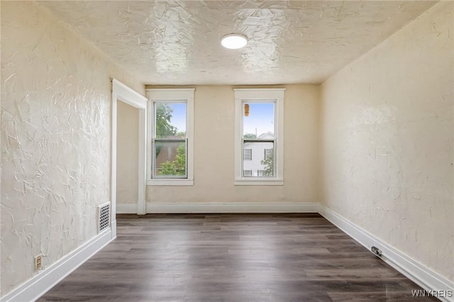 76 Chester St, Buffalo, NY 14208 - unfurnished room featuring a textured wall, dark wood-style floors, and a textured ceiling