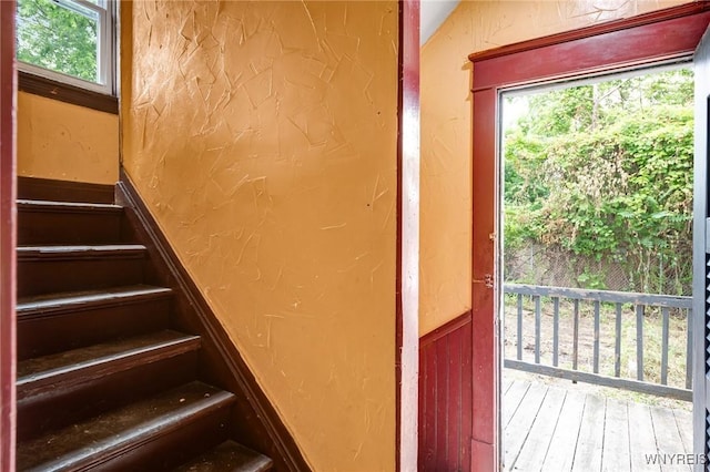 76 Chester St, Buffalo, NY 14208 - staircase featuring healthy amount of natural light, a textured wall, and wood finished floors