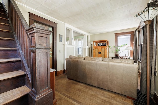 36.5 Austin St, Rochester, NY 14606 - living area featuring wood finished floors, stairway, plenty of natural light, ornamental molding, and ornate columns