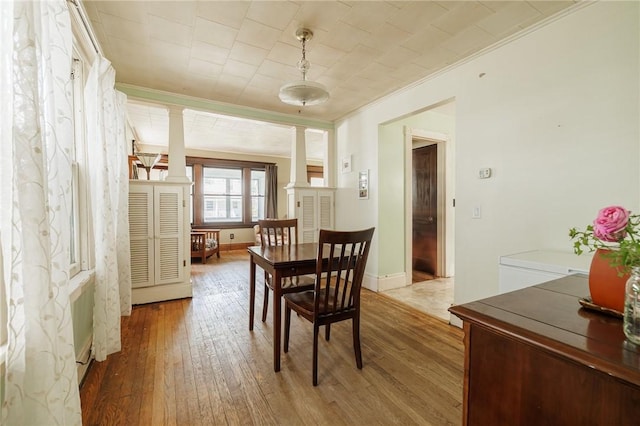 36.5 Austin St, Rochester, NY 14606 - dining room featuring ornate columns, crown molding, and hardwood / wood-style floors