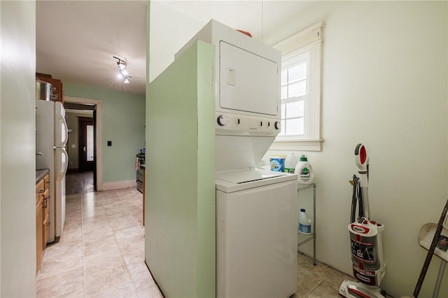 36.5 Austin St, Rochester, NY 14606 - laundry area with stacked washer and clothes dryer and light tile patterned floors