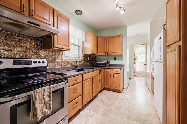 36.5 Austin St, Rochester, NY 14606 - kitchen with stainless steel electric range, under cabinet range hood, dark countertops, backsplash, and light tile patterned floors