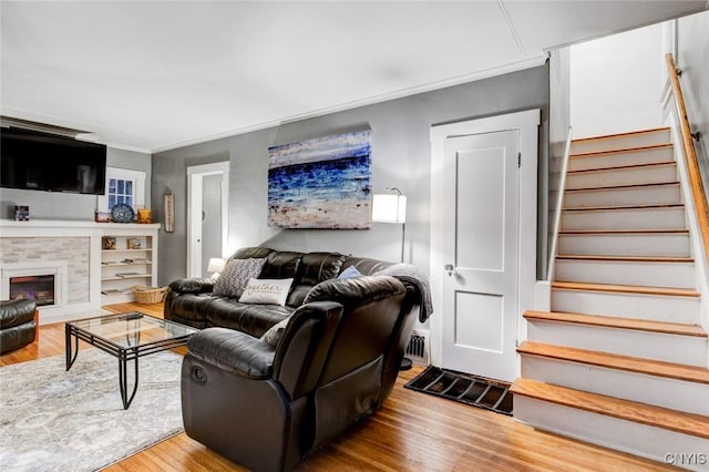 301 Arlington Ave Unit 3, Syracuse, NY 13207 - living area with stairway, wood finished floors, ornamental molding, and a glass covered fireplace