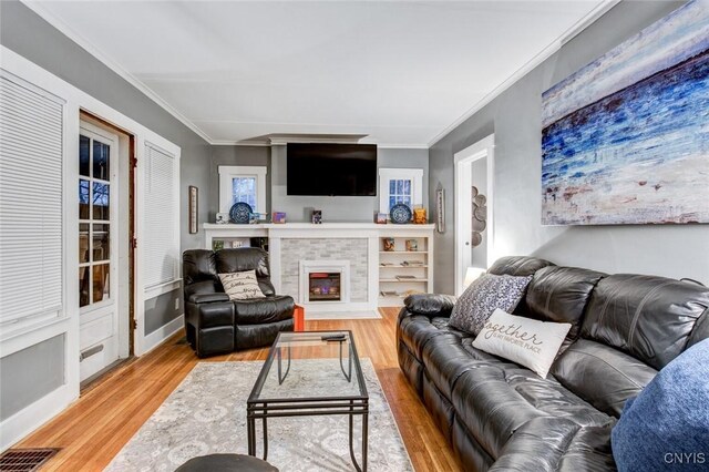 301 Arlington Ave Unit 3, Syracuse, NY 13207 - living area featuring crown molding, wood finished floors, and a fireplace with flush hearth