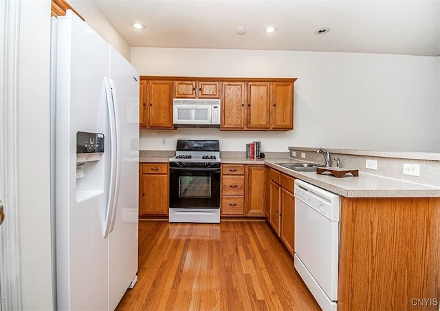 4203 Sandbar Ln, Clay, NY 13090 - kitchen featuring white appliances, light wood-type flooring, brown cabinets, light countertops, and a peninsula
