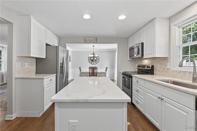 208 Single Dr, Clay, NY 13212 - kitchen with appliances with stainless steel finishes, a center island, white cabinetry, backsplash, and recessed lighting