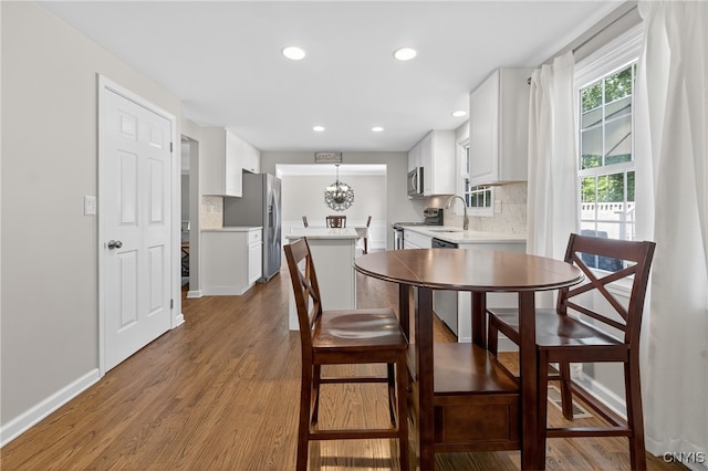 208 Single Dr, Clay, NY 13212 - dining room featuring wood finished floors, recessed lighting, and a chandelier