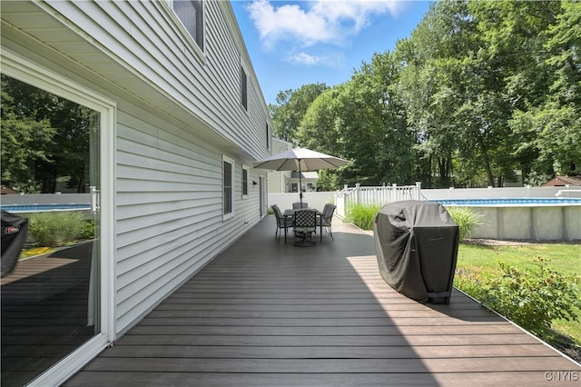 208 Single Dr, Clay, NY 13212 - deck with outdoor dining area, grilling area, a fenced backyard, and view of scattered trees