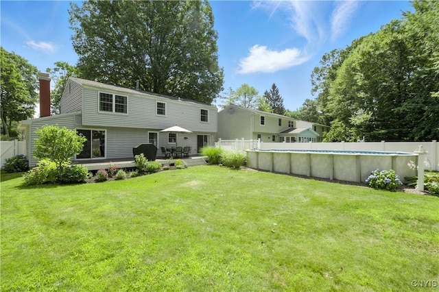 208 Single Dr, Clay, NY 13212 - back of house featuring a deck, a fenced backyard, and a chimney