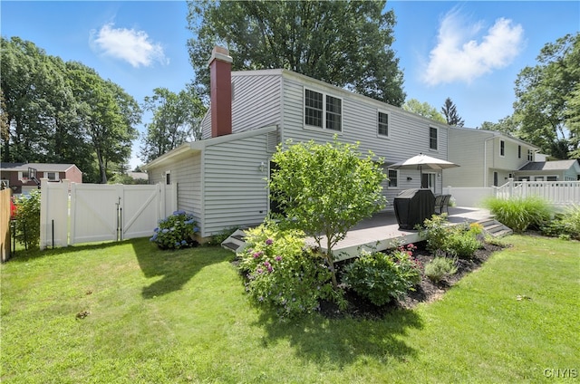 208 Single Dr, Clay, NY 13212 - rear view of property with a gate, a deck, and a chimney