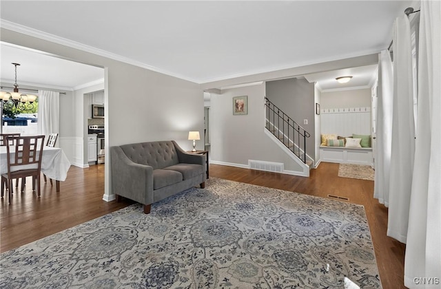 208 Single Dr, Clay, NY 13212 - living room with a chandelier, wood finished floors, stairs, and crown molding