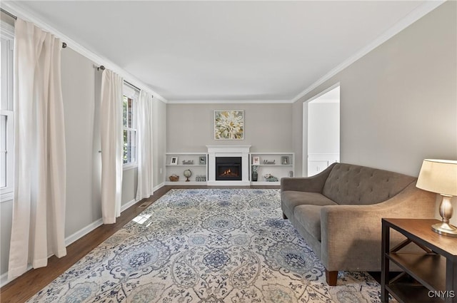 208 Single Dr, Clay, NY 13212 - living area featuring wood finished floors, crown molding, and a warm lit fireplace