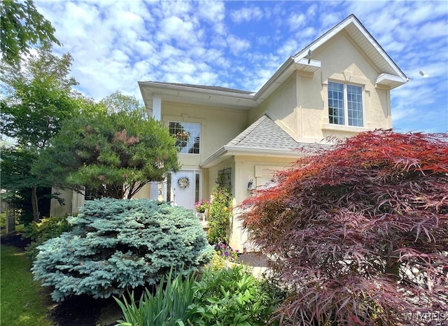 39 Wickendon Ct, Amherst, NY 14221 - view of side of home with stucco siding and a shingled roof