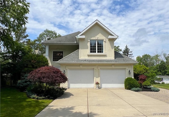 39 Wickendon Ct, Amherst, NY 14221 - view of front of property with stucco siding, a shingled roof, concrete driveway, and a garage