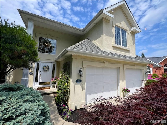 39 Wickendon Ct, Amherst, NY 14221 - traditional-style house with stucco siding, a shingled roof, and a garage