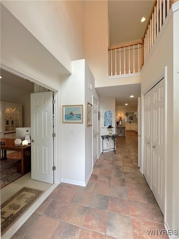 39 Wickendon Ct, Amherst, NY 14221 - hallway with a towering ceiling and baseboards