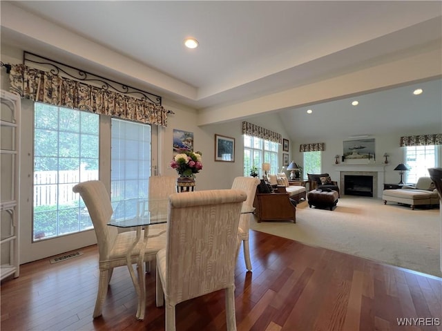 39 Wickendon Ct, Amherst, NY 14221 - dining room with wood finished floors, a fireplace, recessed lighting, and lofted ceiling