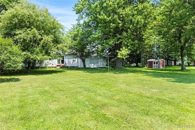 301 Pleasant View Dr, Lancaster, NY 14086 - view of grassy yard with a storage shed and a detached garage