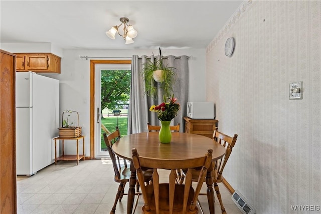 301 Pleasant View Dr, Lancaster, NY 14086 - dining area featuring baseboards and a chandelier