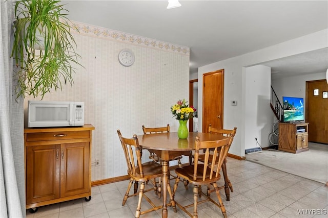 301 Pleasant View Dr, Lancaster, NY 14086 - dining area featuring stairway, light flooring, and wallpapered walls