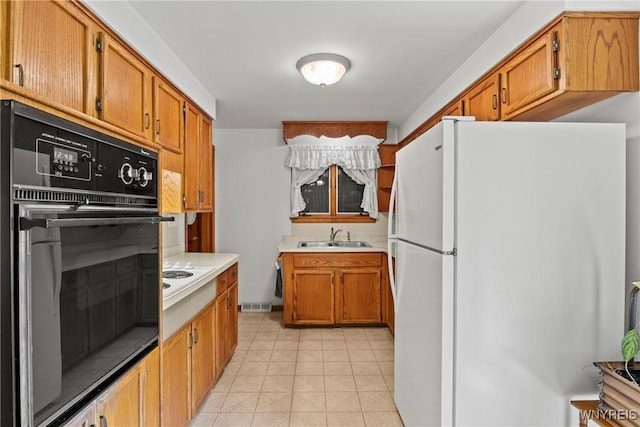 301 Pleasant View Dr, Lancaster, NY 14086 - kitchen with white appliances, light countertops, and brown cabinets