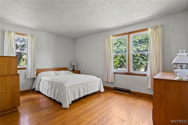 301 Pleasant View Dr, Lancaster, NY 14086 - bedroom featuring wood finished floors, multiple windows, and a textured ceiling