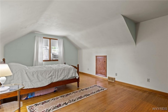 301 Pleasant View Dr, Lancaster, NY 14086 - bedroom featuring wood finished floors, lofted ceiling, and cooling unit