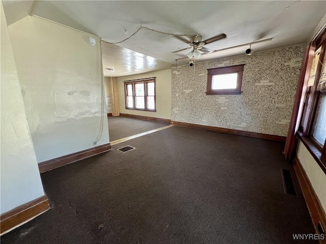 83 Andover Ave, Buffalo, NY 14215 - empty room featuring ceiling fan, wallpapered walls, and a smoke detector