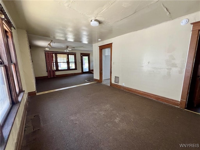 83 Andover Ave, Buffalo, NY 14215 - unfurnished living room featuring baseboards and a ceiling fan
