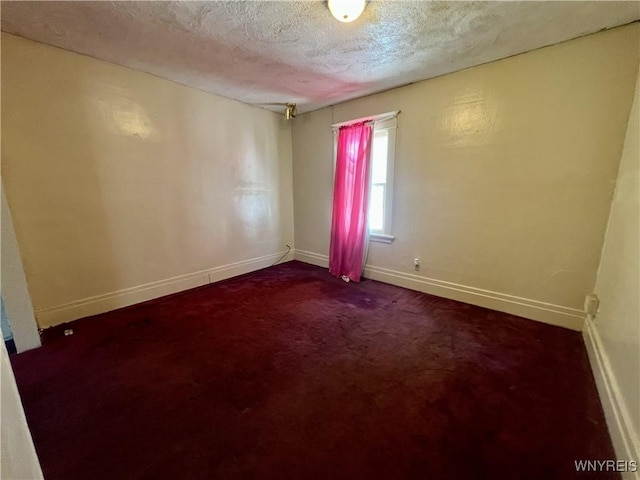 83 Andover Ave, Buffalo, NY 14215 - empty room featuring dark carpet and a textured ceiling