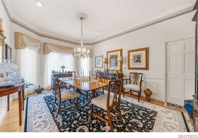 7 The Hamlet, Amherst, NY 14051 - dining room featuring ornamental molding, light wood-style floors, and a chandelier