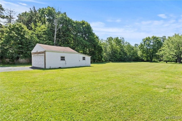 1419 Maple Rd, Amherst, NY 14221 - view of green lawn featuring an outbuilding, a detached garage, and asphalt driveway