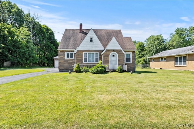1419 Maple Rd, Amherst, NY 14221 - english style home featuring a chimney, a front lawn, a garage, stone siding, and asphalt driveway