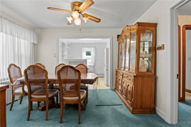1419 Maple Rd, Amherst, NY 14221 - dining area featuring a ceiling fan, light colored carpet, and radiator
