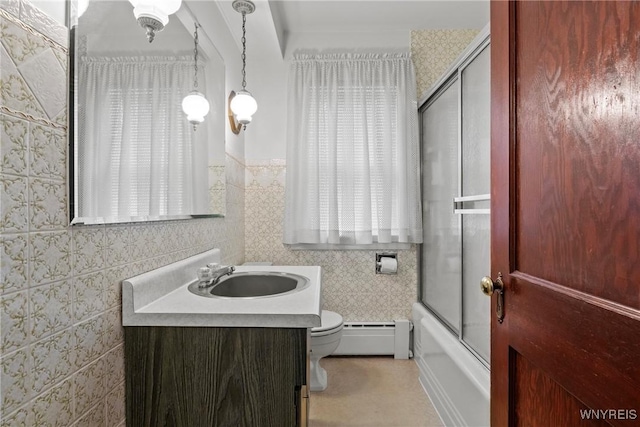 1419 Maple Rd, Amherst, NY 14221 - full bathroom featuring a baseboard radiator, vanity, and bath / shower combo with glass door