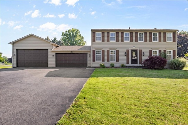 193 Orchard Creek Ln, Greece, NY 14612 - colonial home featuring asphalt driveway, an attached garage, and a front lawn