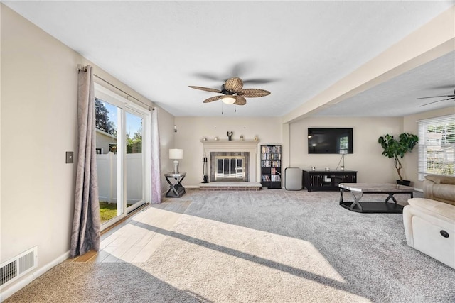 193 Orchard Creek Ln, Greece, NY 14612 - carpeted living area with ceiling fan and a fireplace