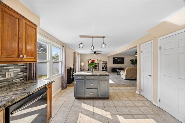 193 Orchard Creek Ln, Greece, NY 14612 - kitchen with a ceiling fan, backsplash, stainless steel dishwasher, brown cabinets, and light tile patterned flooring