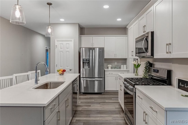 3398 Cedar Valley Way, Hamburg, NY 14075 - kitchen with appliances with stainless steel finishes, wood finished floors, light countertops, recessed lighting, and pendant lighting