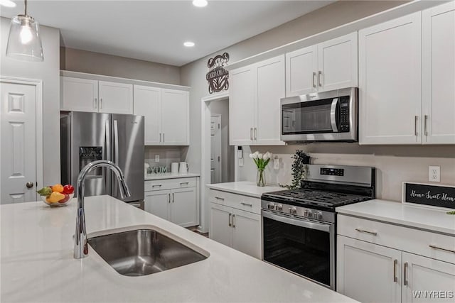 3398 Cedar Valley Way, Hamburg, NY 14075 - kitchen with appliances with stainless steel finishes, recessed lighting, white cabinetry, light countertops, and decorative light fixtures