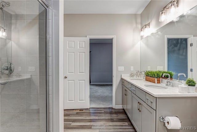 3398 Cedar Valley Way, Hamburg, NY 14075 - bathroom featuring wood finished floors, double vanity, and a stall shower