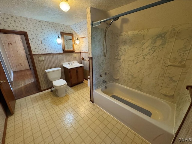 410 W Elm St, Oneida, NY 13421 - bathroom with wallpapered walls, vanity,  shower combination, wainscoting, and a textured ceiling