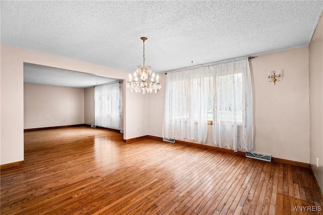 270 N French Rd, Amherst, NY 14228 - spare room with a chandelier, hardwood / wood-style flooring, and a textured ceiling
