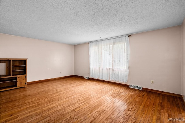 270 N French Rd, Amherst, NY 14228 - unfurnished living room with hardwood / wood-style flooring and a textured ceiling