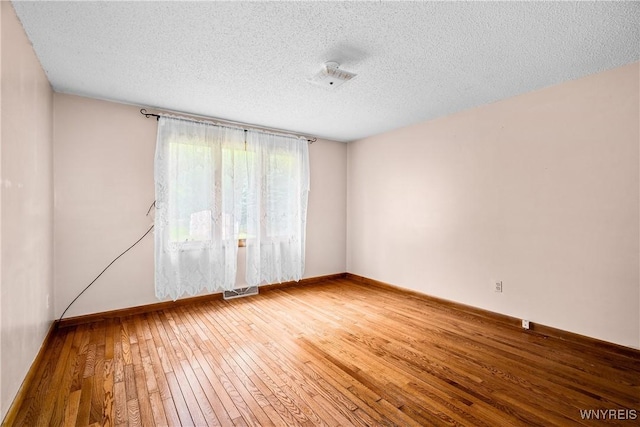 270 N French Rd, Amherst, NY 14228 - empty room with a textured ceiling and hardwood / wood-style floors