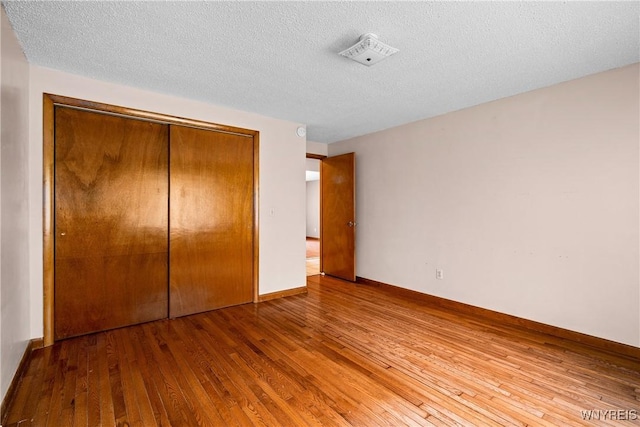 270 N French Rd, Amherst, NY 14228 - unfurnished bedroom featuring hardwood / wood-style flooring, a closet, and a textured ceiling