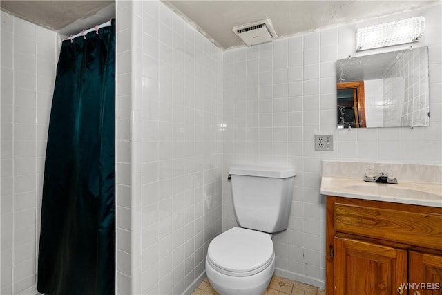 270 N French Rd, Amherst, NY 14228 - bathroom with vanity, curtained shower, tile patterned floors, and tile walls