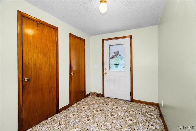 270 N French Rd, Amherst, NY 14228 - foyer entrance with baseboards and a textured ceiling